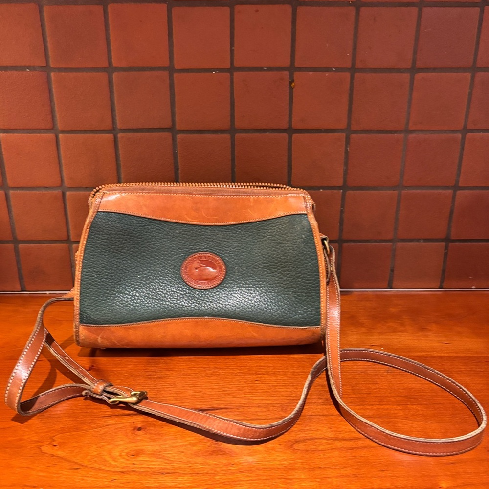 Vintage leather hunter green Dooney and Bourke crossbody purse with brass zipper